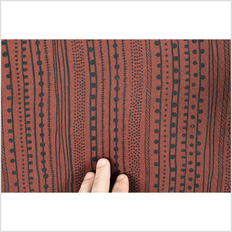 Rust copper brown textured cotton fabric, heavy weight and thick, mud cloth style black screen print in neutral earth-tone color PHA198